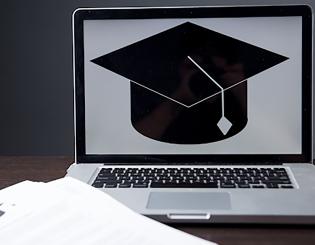 Graduation cap on laptop screen 